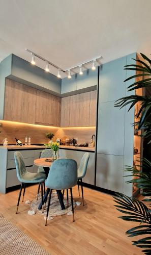 a kitchen with a table and chairs in a room at Kaltak Luxury Stay in Bar