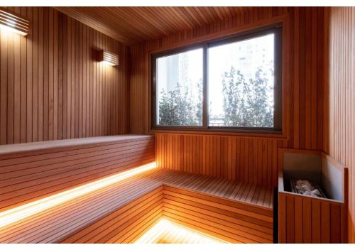 a sauna with a window and a cat sitting in it at House of Charlie Paraiso in Sao Paulo