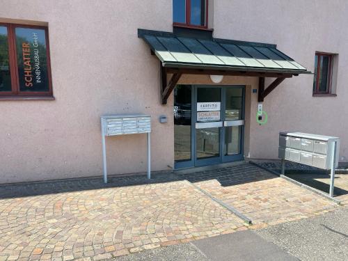 a store front with awning in front of a building at CoLiving Steinmaur in Dielsdorf