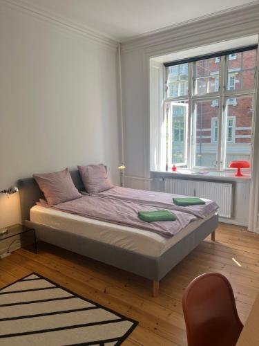 a bedroom with a bed and a window at Topcity in Copenhagen