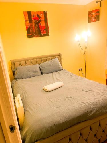 a bedroom with a bed with a white towel on it at Wilsuel homestay in Wolverhampton