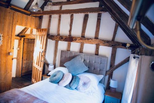 a bedroom with a bed with blue and white pillows at Ye Olde Cottage in Crawley
