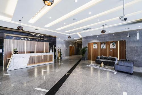 a lobby with a couch and a table at Cozy Studio at walking distance from Burj Khalifa and Downtown Dubai in Dubai