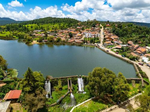 an aerial view of a small town next to a lake at Cabaña Alua in Ferrería de Tula