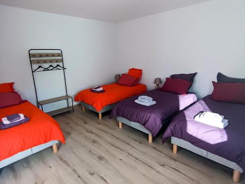 a room with three beds with orange and purple at Gîte de charme dans Les Vosges du sud, parfait pour 14 personnes - FR-1-583-511 in La Corbière