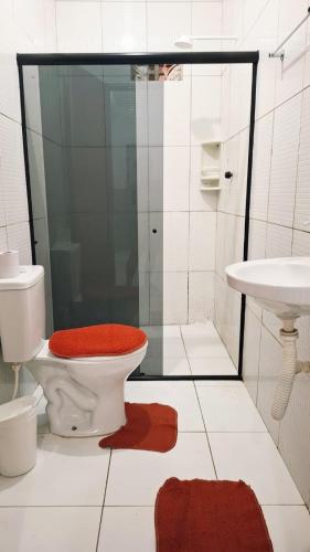 a bathroom with a toilet and a shower and a sink at Enseadabechouse in Cabo de Santo Agostinho
