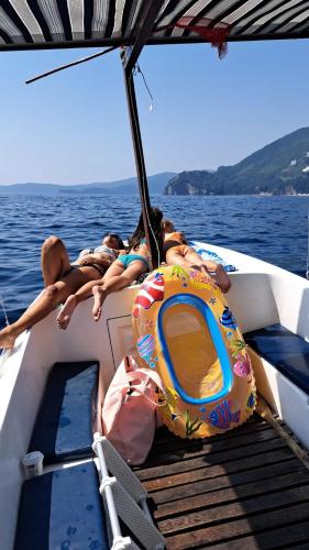 a group of people laying on the back of a boat at Apartments Dragišić in Sveti Stefan