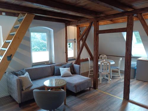 a living room with a couch and a table at Ferienhaus hERZgebirge in Bockau