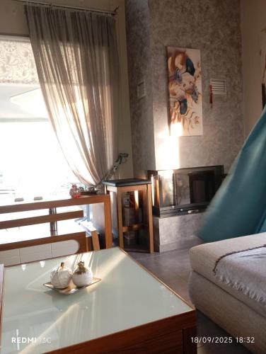 a living room with a coffee table and a couch at Lia Luxury home 2ΥΔ 110 τ μ in Chrysoupolis