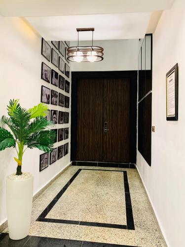 a hallway with a door and a potted plant at Alphavista Luxury Apartments in Port Harcourt