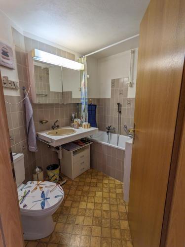 a bathroom with a toilet and a sink and a tub at Apartment Above the Rooftops - Mountain Panorama in Naters