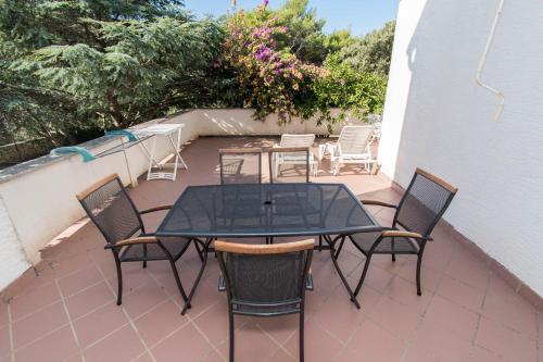 a patio with a table and chairs on a balcony at Apartment Family Ribicic in Mandre