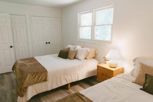 a bedroom with two beds and a window at "Morning View 4” Cozy Modern Stay - College/Hiking in Berea