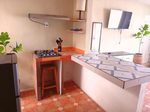 a kitchen with a stove and a counter top at Lindo departamento in Toluca