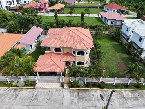 an aerial view of a house with an orange roof at Spacious Beach House with Pool in Gated Community 