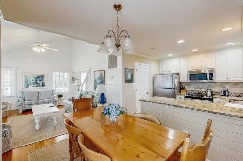 a kitchen and living room with a wooden dining table at Pelican Bay 42 in Isle of Palms
