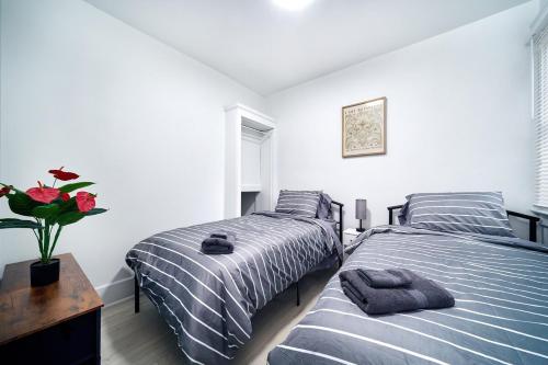 a bedroom with two beds and a vase of flowers at Newly renovated 3 bedroom unit in Windsor