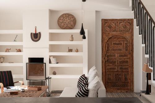 a living room with a large wooden door at La Mouette et les Dromadaires in Essaouira