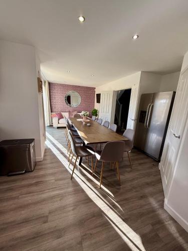a kitchen and dining room with a table and chairs at Elysian Escape, modern 5 bedroom house in Darlington