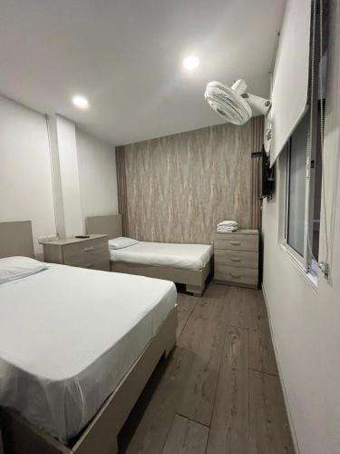 a hotel room with two beds and a window at Hotel 42 Avenida in Palmira