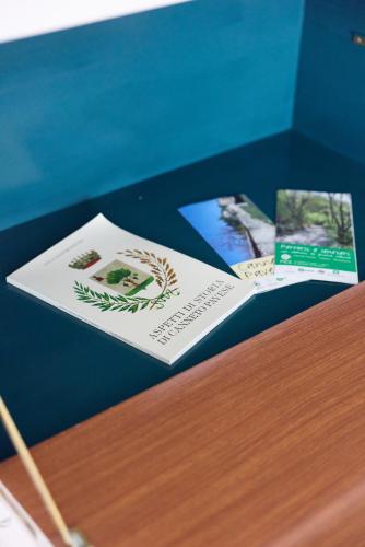 two brochures sitting on top of a wooden table at Oltre Natura in Canneto Pavese