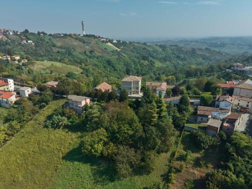 an aerial view of a small village on a hill at Oltre Natura in Canneto Pavese