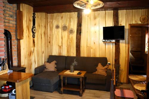 a living room with a couch and a table at Ruralna kuća za odmor Brezanka, Zagrebačka ulica 21 Gornja Stubica in Gornja Stubica