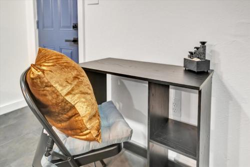 a chair with a table with a pillow on it at Walk to Stadium, 2 Parking spots, Dog Park, BBQ in Tampa
