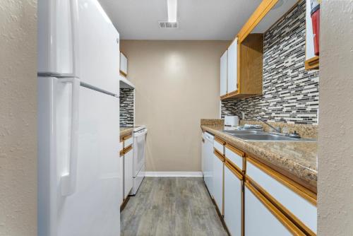 a kitchen with a refrigerator and a sink at Beaujolais Villas 