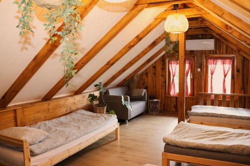 a bedroom with two beds in a attic at Ruralna kuća za odmor Brezanka, Zagrebačka ulica 21 Gornja Stubica in Gornja Stubica