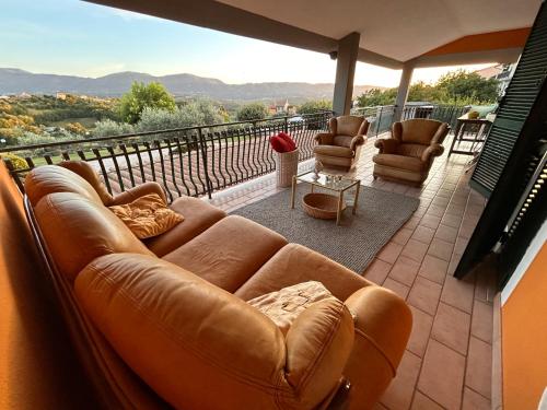 a living room with a couch and chairs on a balcony at Casa relax e vacanza Il Moraiolo in Stroncone