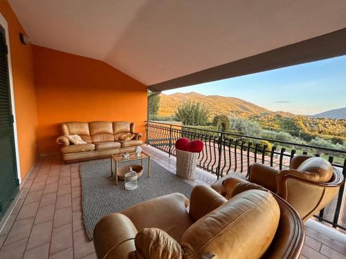 a living room with a couch and chairs on a balcony at Casa relax e vacanza Il Moraiolo in Stroncone
