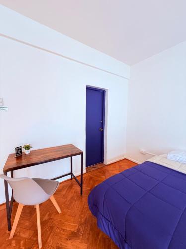 a bedroom with a bed and a desk and a chair at MAKTVB Europa - Hostal Boutique in Santiago