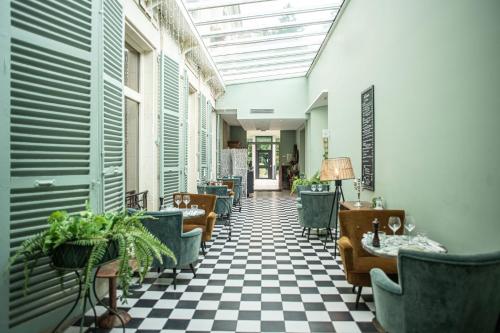 a lobby with a checkered floor and chairs at Hotel Novotel Domaine de Maffliers - Paris Val-d'Oise in Maffliers