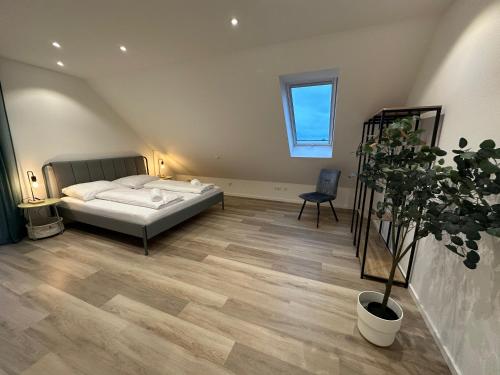 a bedroom with a bed and a potted plant at Perfekt für 6-8! Küche Parkplätze Flughafen in Hallbergmoos
