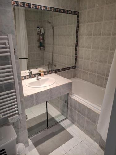 a bathroom with a sink and a bath tub at wonderful sea view in Antibes