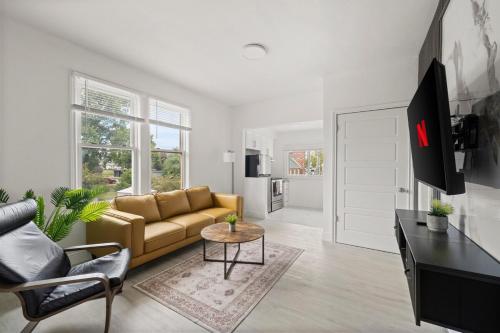 a living room with a couch and a table at New Build Open 2 Bedroom Unit in Windsor