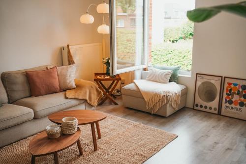 a living room with a couch and a table at Stylish accommodation with dressing room & workspace in Antwerp