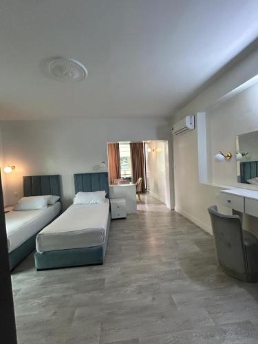 a hotel room with two beds and a bathroom at Crystal hotel in Tangier