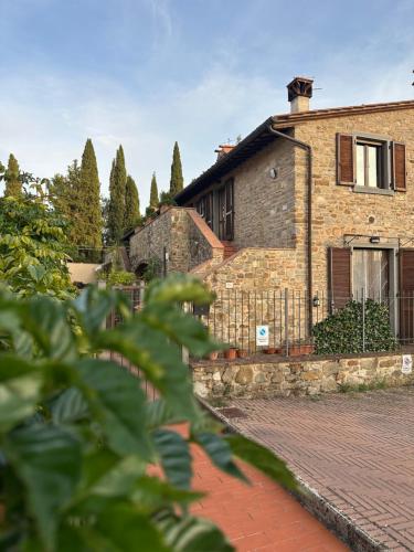 a brick house with a fence in front of it at Under The Tuscan Sun in Arezzo