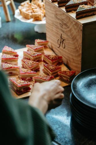 a person reaching for a bunch of sandwiches on a table at Hotel Novotel Domaine de Maffliers - Paris Val-d'Oise in Maffliers