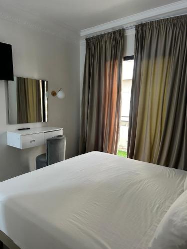 a bedroom with a large white bed and a window at Crystal hotel in Tangier