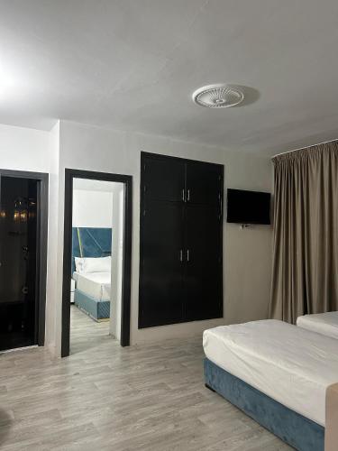 a bedroom with two beds and a mirror at Crystal hotel in Tangier
