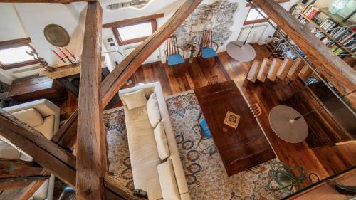 an overhead view of a living room with wood floors at Dolomites Luxury Penthouse in Agordo