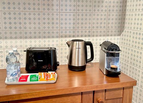 a counter top with a coffee maker and a coffee pot at Tre Ponti Beach Apartment - sea view in Sanremo