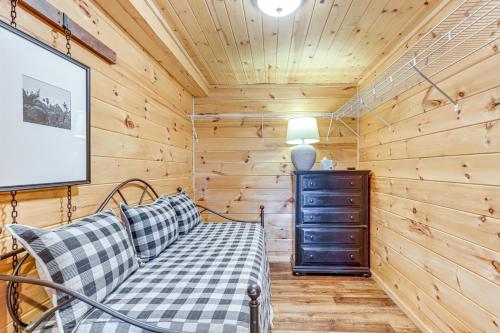 a log cabin living room with a couch and a tv at Deck, Panoramic Views Serene Mineral Bluff Cabin! in Mineral Bluff