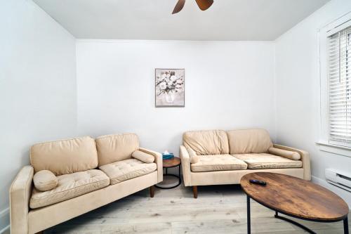a living room with two couches and a table at Bright Quiet One Bedroom Apartment in Windsor