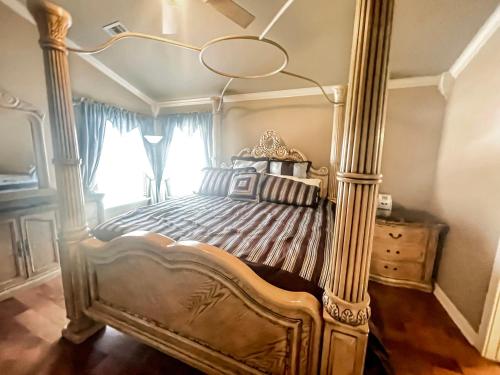 a bedroom with a canopy bed and a window at Casa Oasis Extra Large home centrally located in Johnson