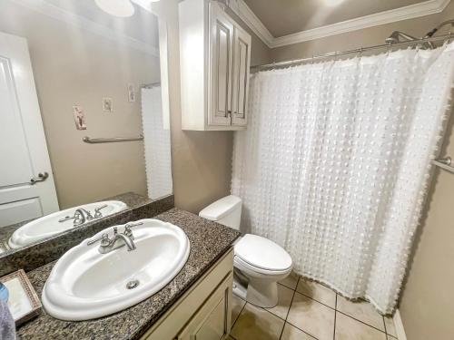 a bathroom with a sink and a toilet and a shower at Casa Oasis Extra Large home centrally located in Johnson