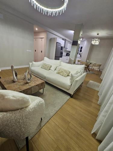 a living room with a white couch and a table at Ático Monarca II in Arrecife
